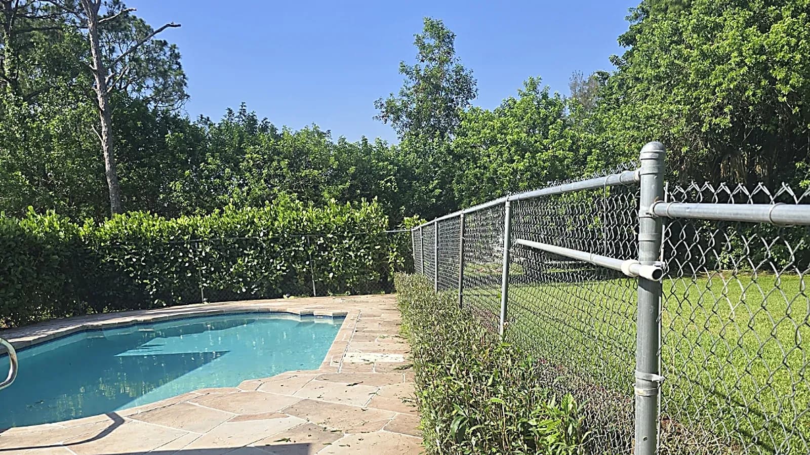 Newly installed pool fence and landscaping completed by Fressly Cut Green Lawn Inc